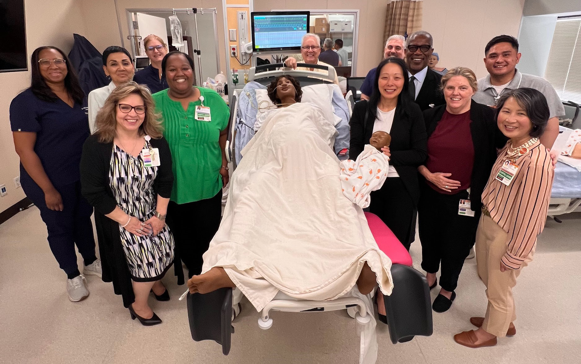 CHMC Foundation board and staff with hospital medical staff and MamaAnne in the Simulation Center CHMC Foundation board and staff with hospital medical staff and MamaAnne in the Simulation Center