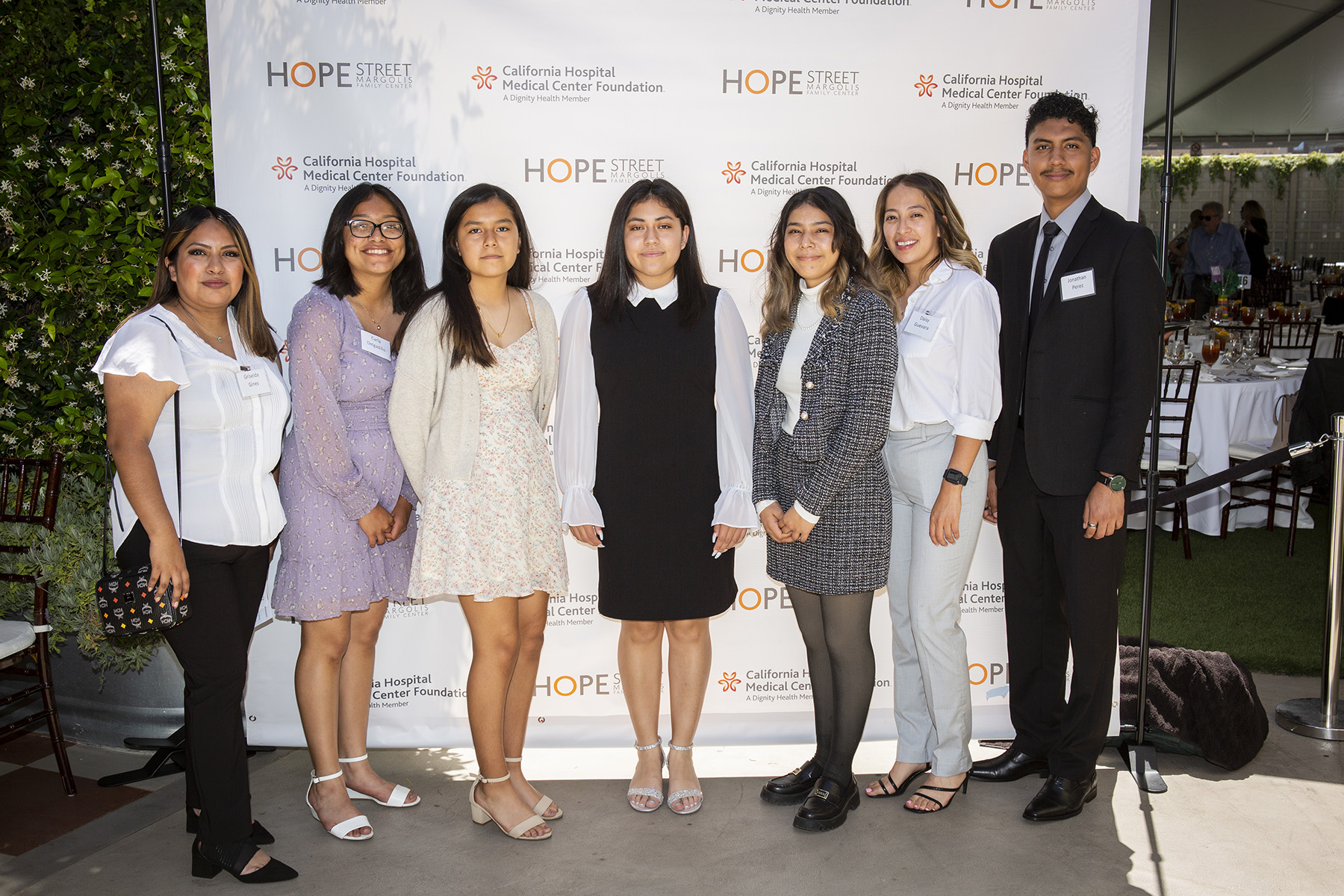 Hope Street alumni posing in front of the step and repeat at the 2022 Champions for Children Luncheon