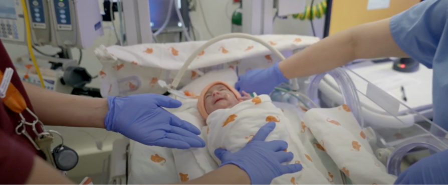 Newborn baby being treated by care team