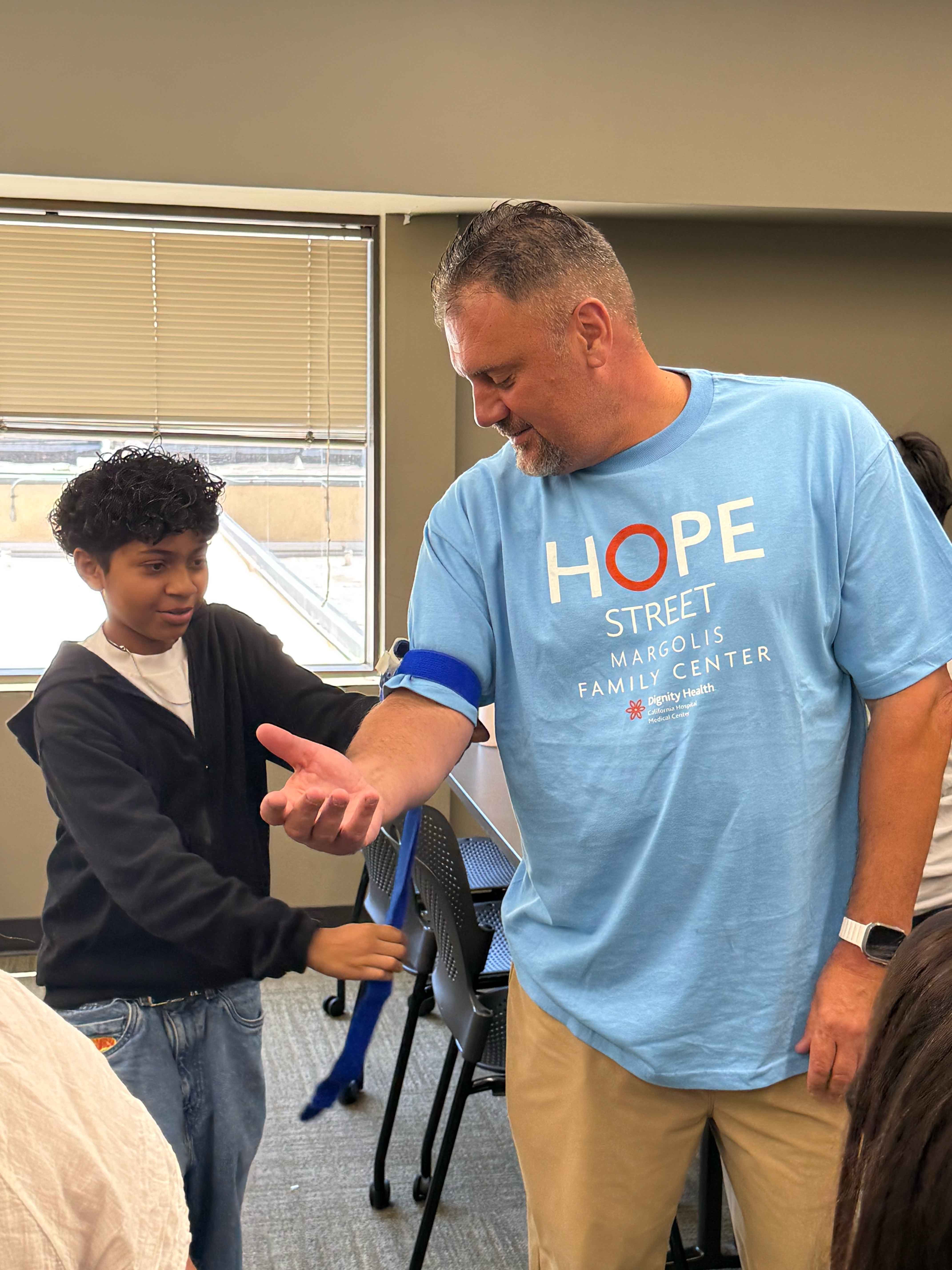 Hope Street student practicing Stop the Bleed training with Hope Street staff