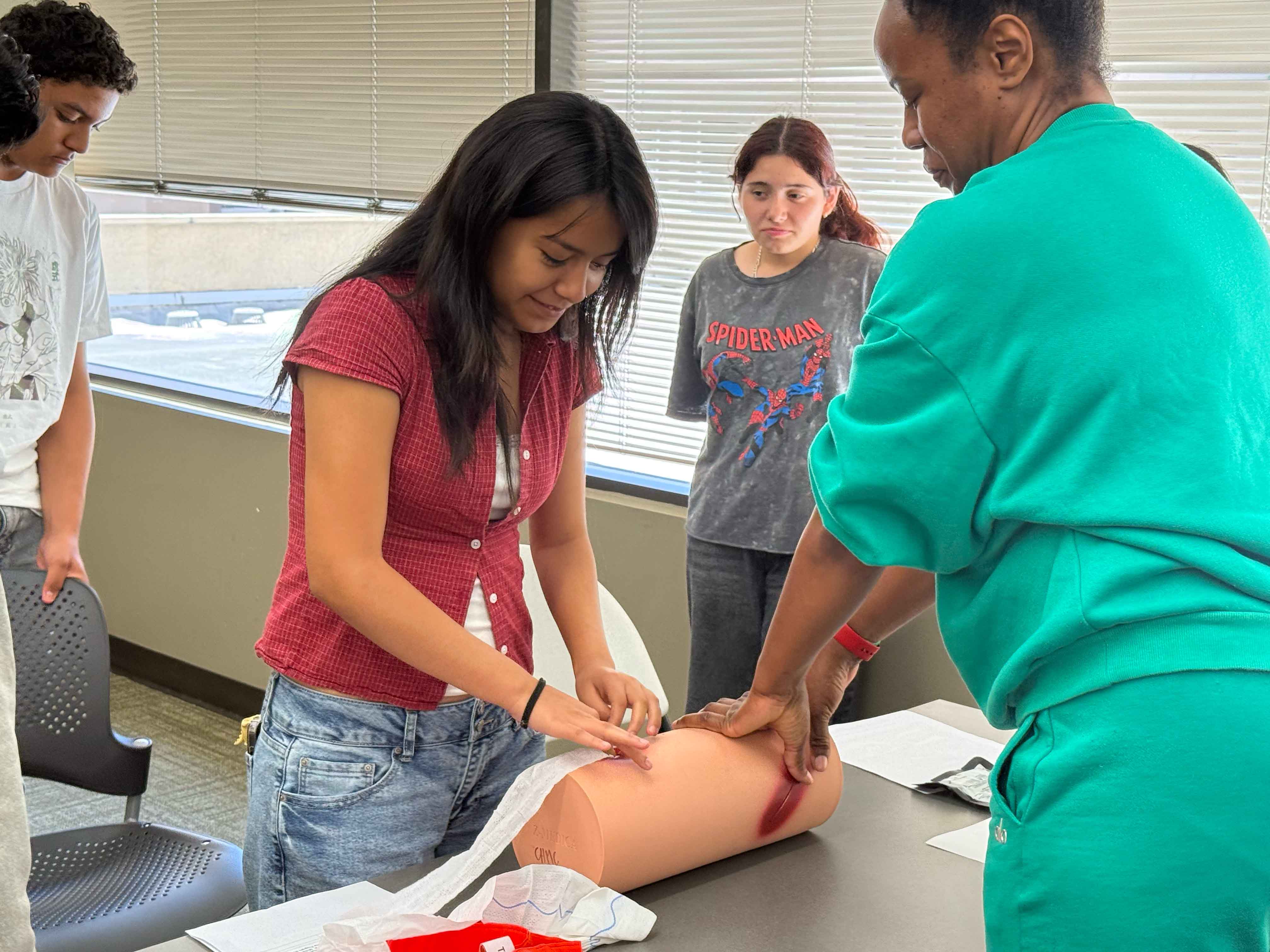 Hope Street student practicing Stop the Bleed training with CHMC trauma nurse